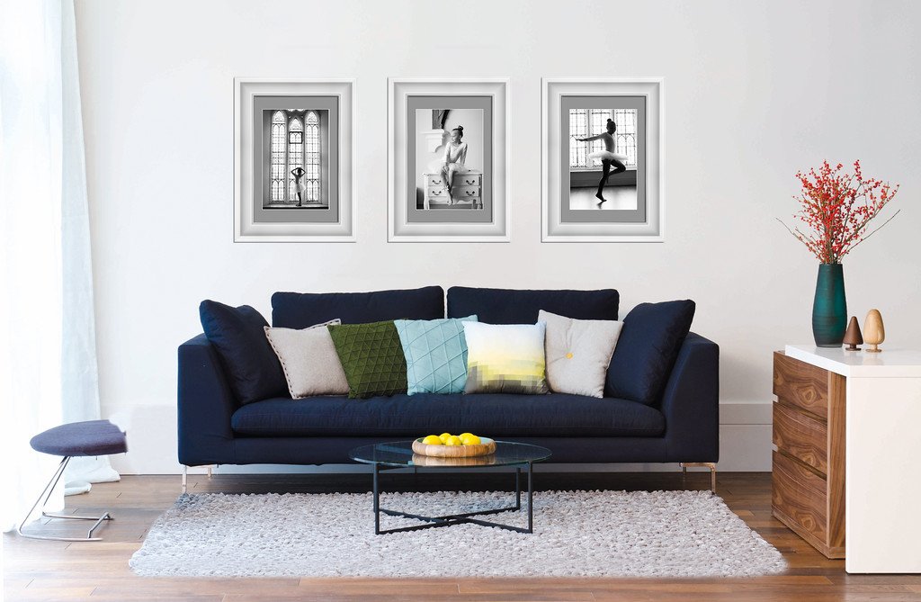Cozy Scottish Borders Wedding Photographer shot. Elegant indoor scene with framed black-and-white photos, stylish sofa, and modern decor.